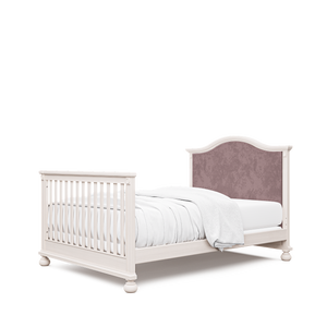 Dakota crib with pink velvet tufted headboard, converted to full bed, in washed white