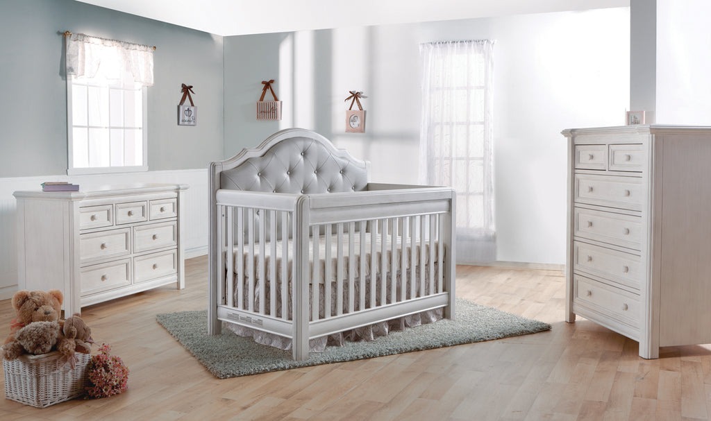 Cristallo Collection in vintage white. Crib with grey vegan leather headboard panel, seven drawer double dresser, and six drawer chest.