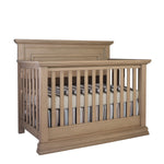 Load image into Gallery viewer, Wooden crib with bedding on a white background
