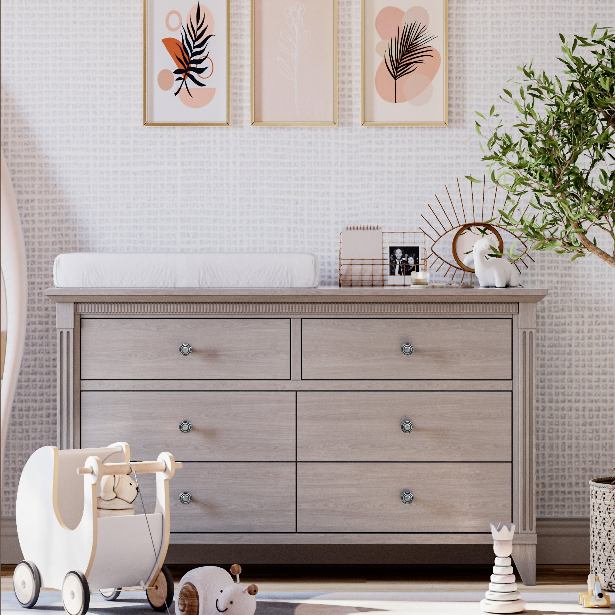 Nursery room with wooden dresser, toy, and decor elements.