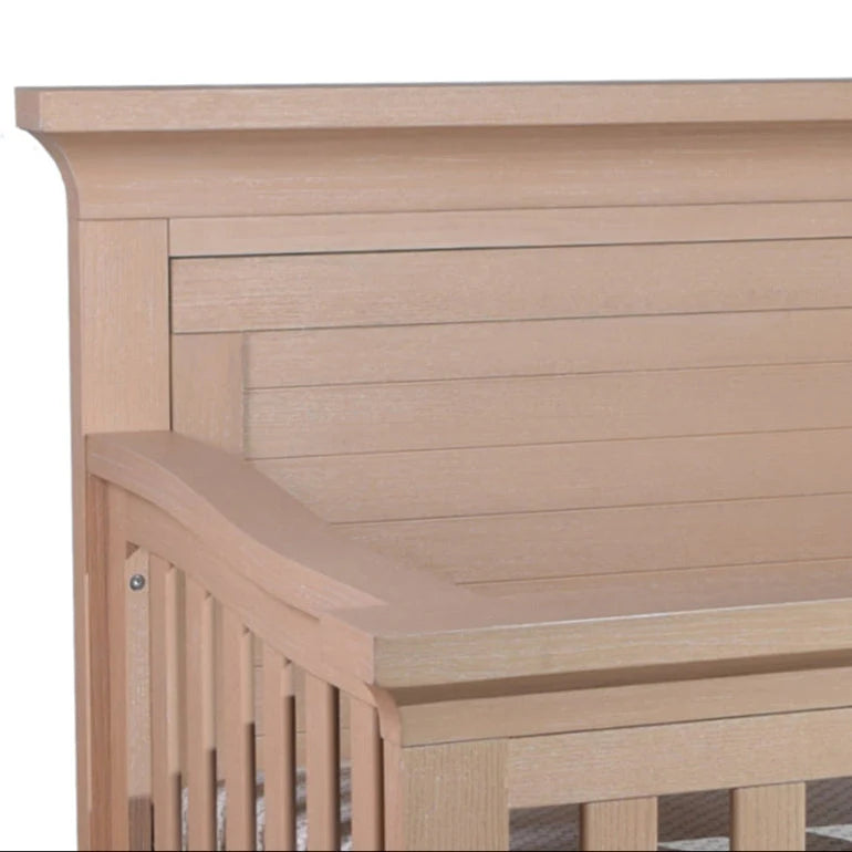 Wooden crib with slatted headboard.