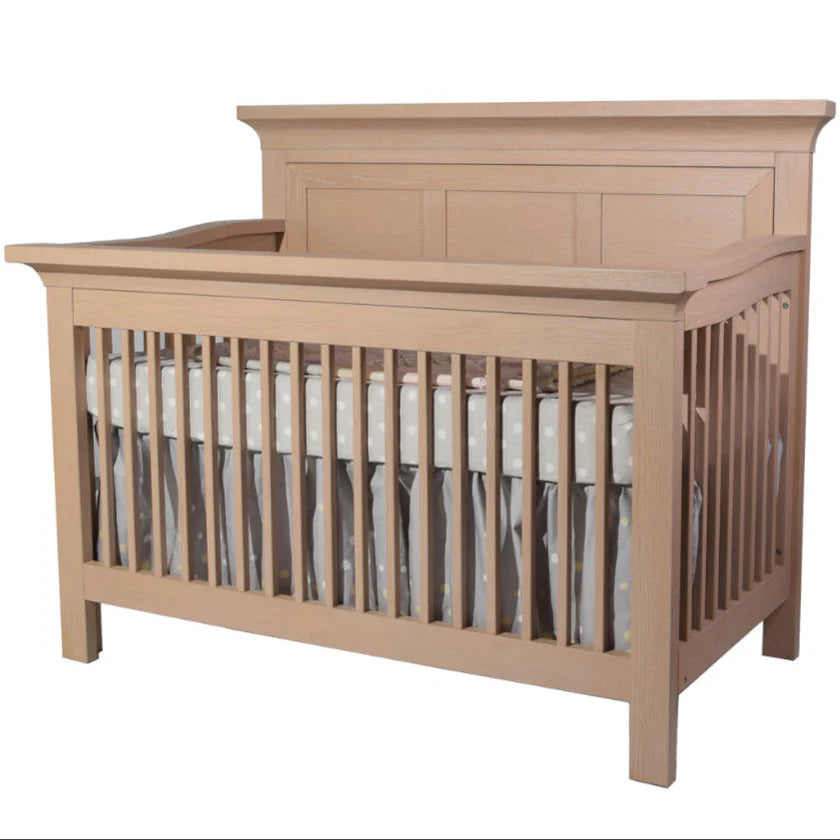 Wooden crib with a white mattress on a white background