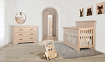 Load image into Gallery viewer, Wooden crib and dresser in a nursery with a wooden toy on the floor.
