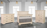 Load image into Gallery viewer, Beige nursery furniture set including a crib, dresser, and chest of drawers in a room with large windows.
