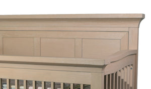 Wooden crib with a detailed headboard