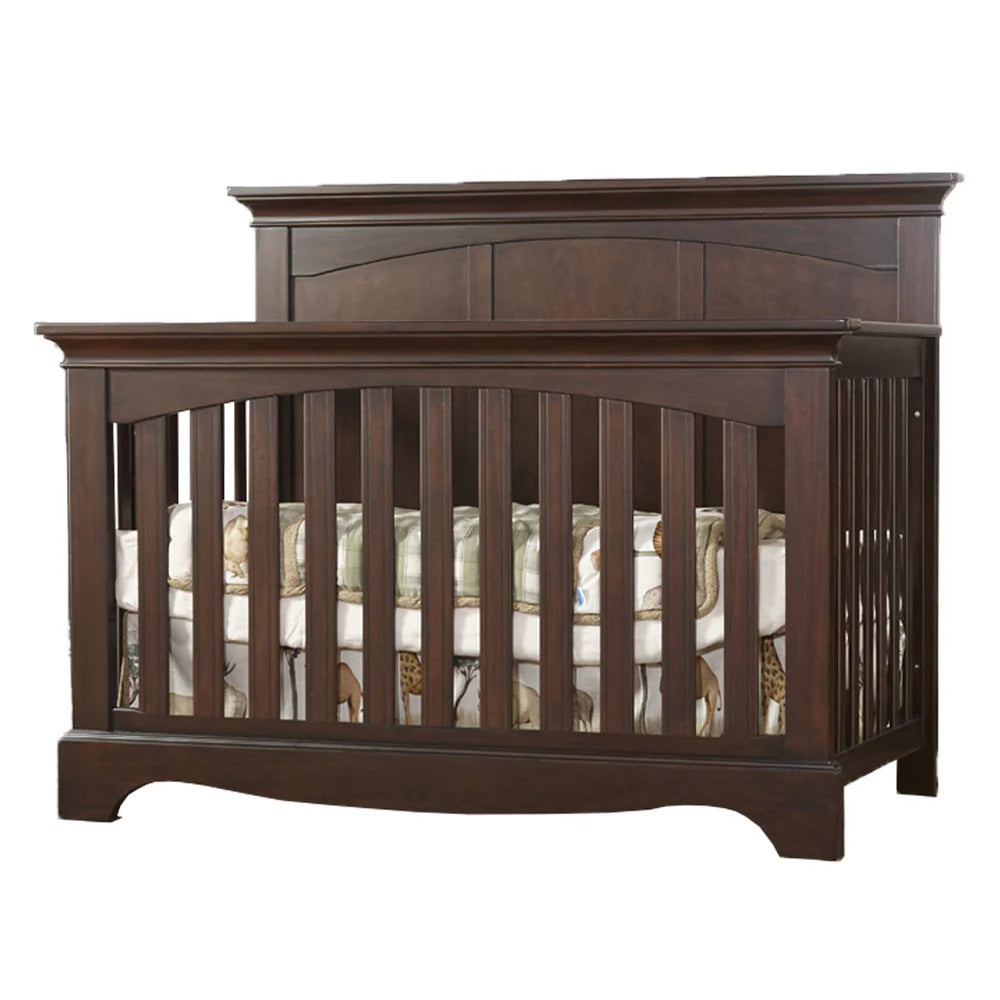 Wooden crib with mattress on a white background