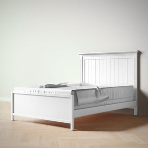 White wooden bed with a headboard on a plain background