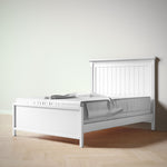 Load image into Gallery viewer, White wooden bed frame with a light gray mattress against a plain white wall.
