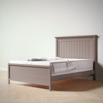 Load image into Gallery viewer, Wooden bed with a white mattress and blanket on a light wooden floor.
