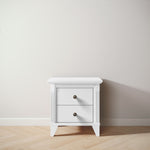 Load image into Gallery viewer, White nightstand with a single drawer on a wooden floor against a plain wall
