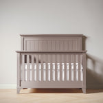 Load image into Gallery viewer, Wooden crib with white mattress against a plain wall
