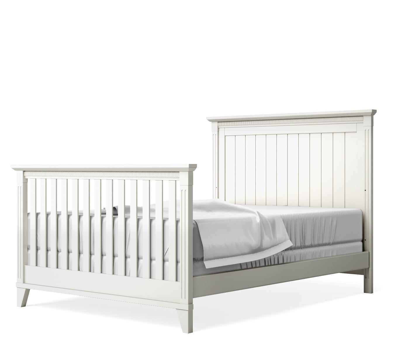 White crib converted to full bed set on a white background
