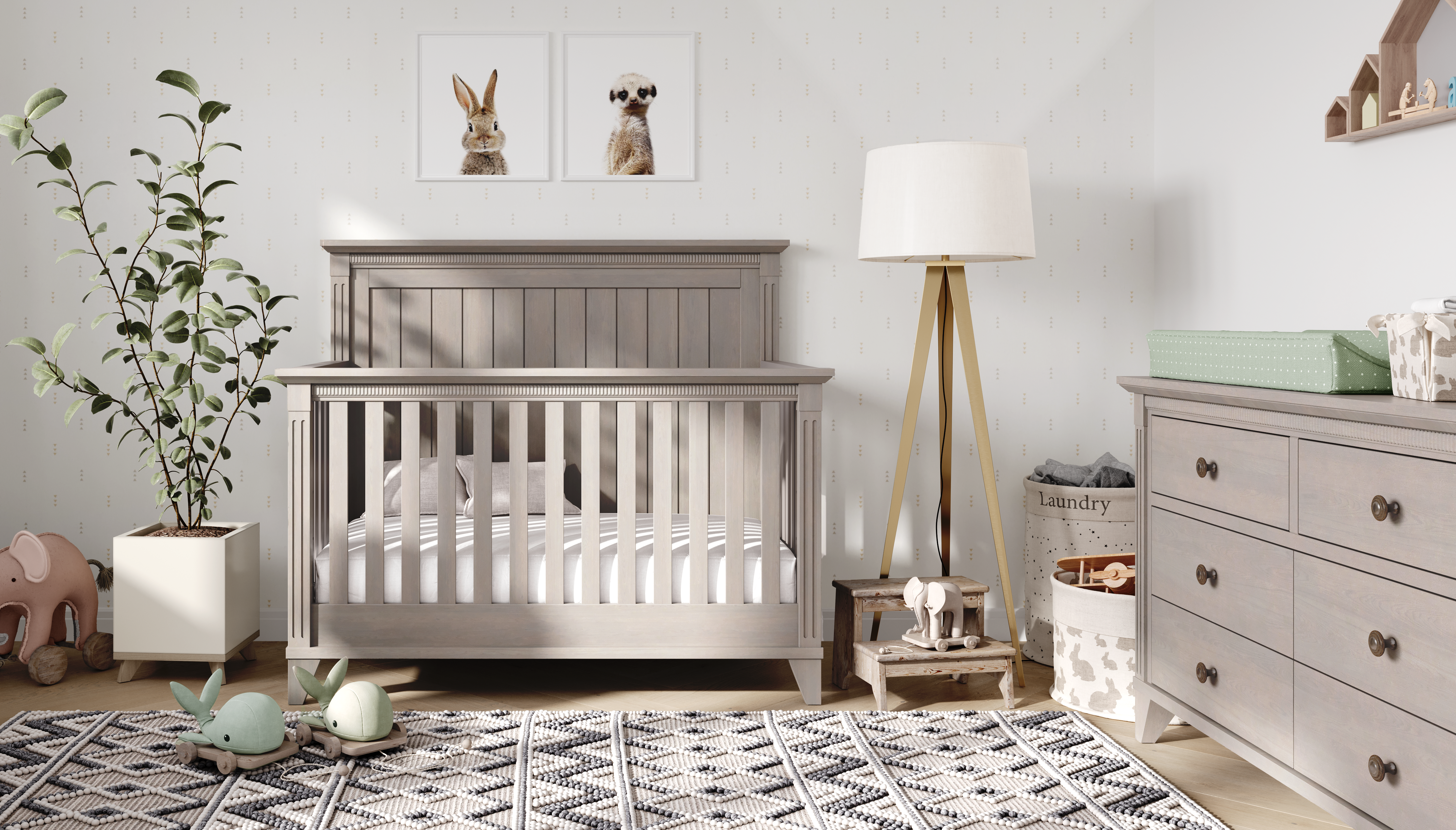 Nursery room with a gray crib, dresser, and decorative elements.