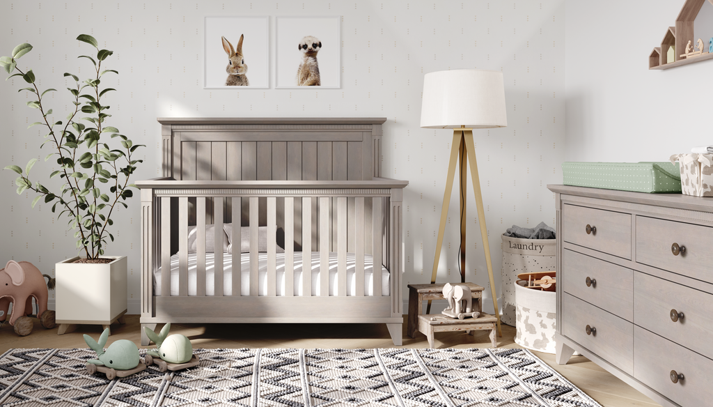 Nursery room with a gray crib, dresser, and decorative elements.