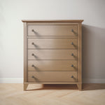 Load image into Gallery viewer, Wooden dresser with five drawers on a wooden floor against a white wall
