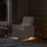 Load image into Gallery viewer, White armchair in a dimly lit room with wooden furniture and a window.
