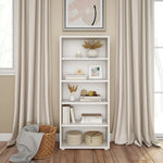 Load image into Gallery viewer, A white five-shelf bookcase stands against a beige wall between two tall beige curtains, styled with books, vases, dried grasses, and small decor items. A woven basket with a gray throw and a framed abstract print are also visible in the room.
