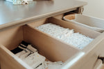 Load image into Gallery viewer, Open dresser drawer, showing drawer dividers, with folded clothes inside
