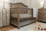Load image into Gallery viewer, Nursery room with a wooden crib, dresser, and toys on the floor.
