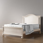 Load image into Gallery viewer, White wash Dakota crib converted to full bed with optional low profile footboard, with white bedding in a minimalistic room.
