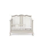 Load image into Gallery viewer, White crib, converted to toddler bed, with a white mattress on a white background
