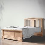 Load image into Gallery viewer, Wooden bed with white bedding on a plain background
