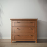 Load image into Gallery viewer, Wooden dresser with three drawers against a plain wall.
