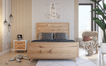 Load image into Gallery viewer, Wooden bed in a bedroom with striped wallpaper and a lighthouse decoration.
