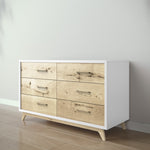 Load image into Gallery viewer, Wooden dresser with white base and light wood drawers against a plain wall.
