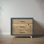 Load image into Gallery viewer, Wooden dresser with blue frame on a wooden floor against a white wall
