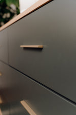 Load image into Gallery viewer, Close up of modern drawer front in rosemary, with gold handle 
