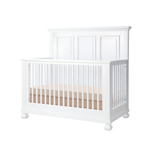 White crib with a  mattress on a white background