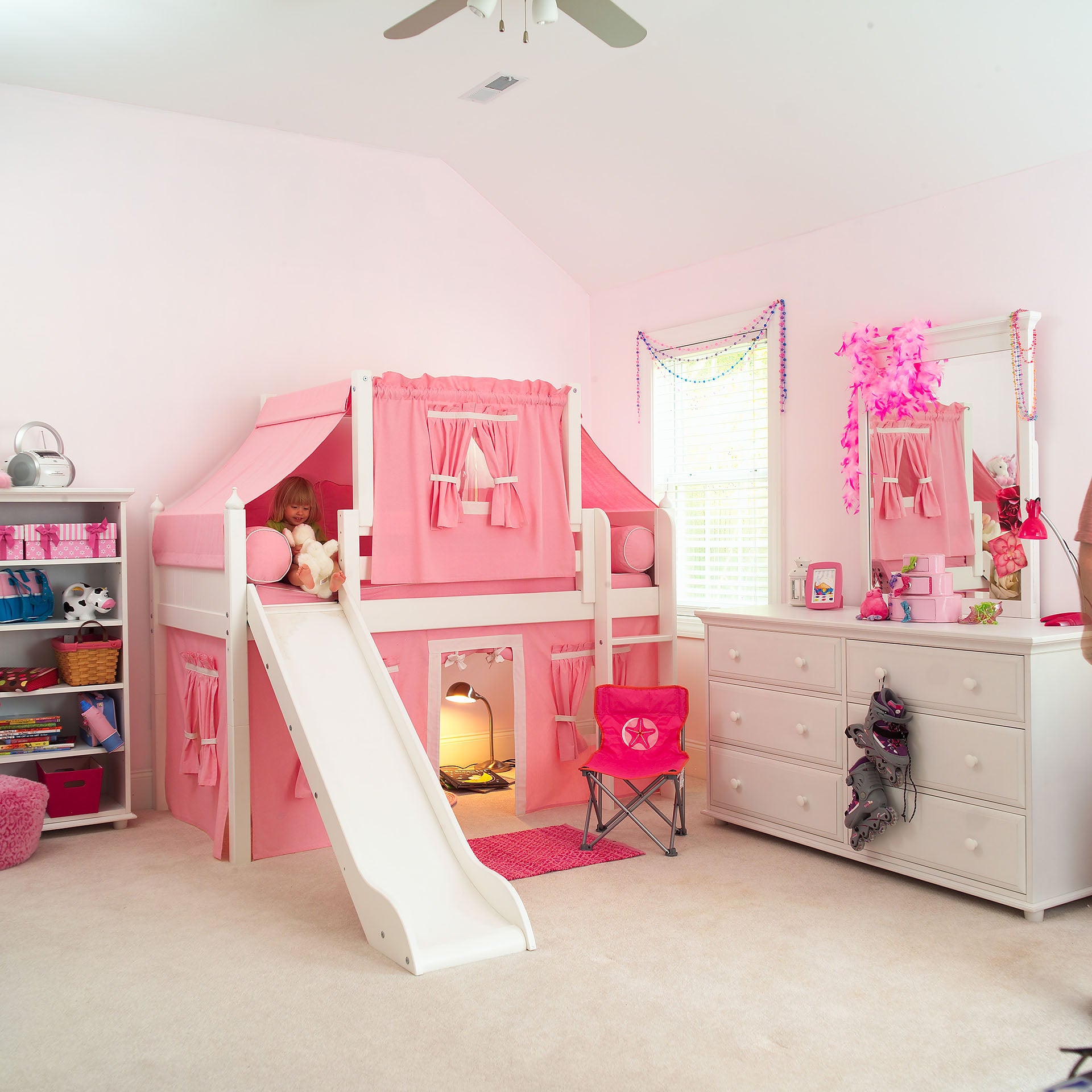 Maxtrix twin size panel style low loft with straight ladder, slide, and top & lower pink tents, shown in white. Also shown: double dresser with mirror and bookcase.